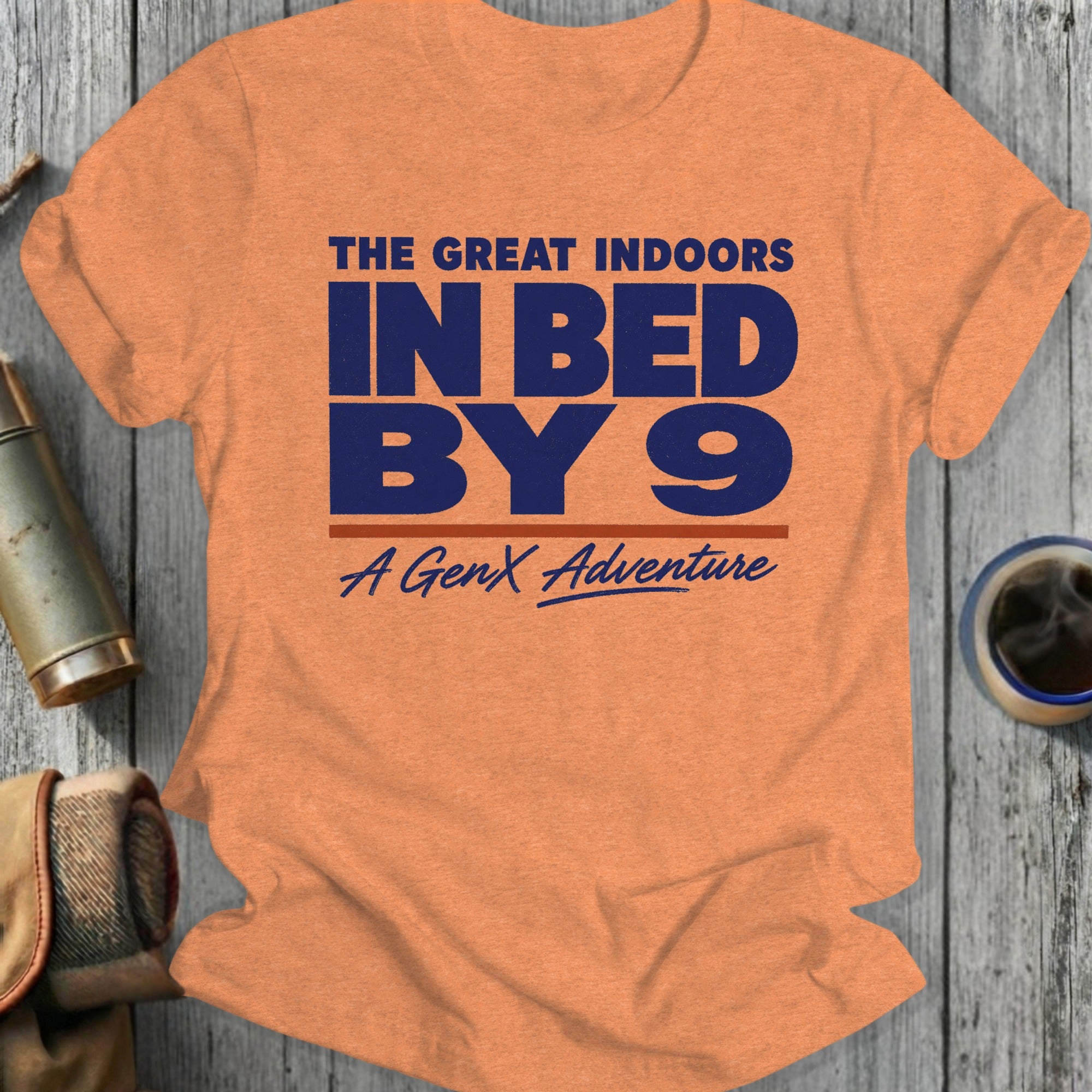 Orange t-shirt with "The Great Indoors In Bed By 9 A GenX Adventure" text.