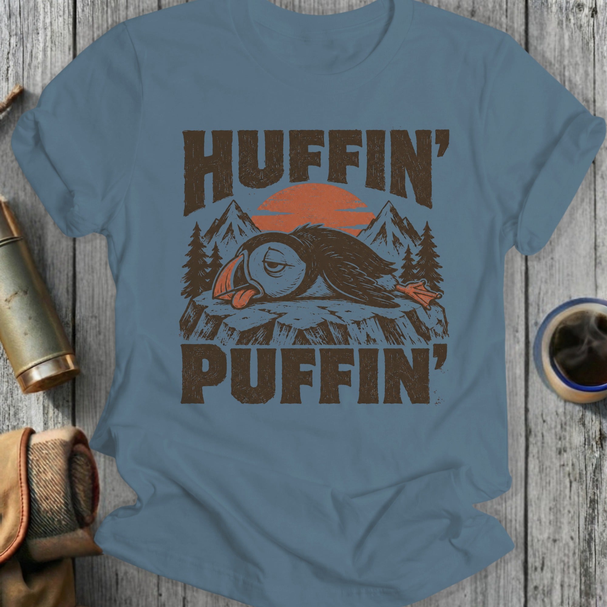 Tired puffin with text "HUFFIN' PUFFIN'" and mountains.