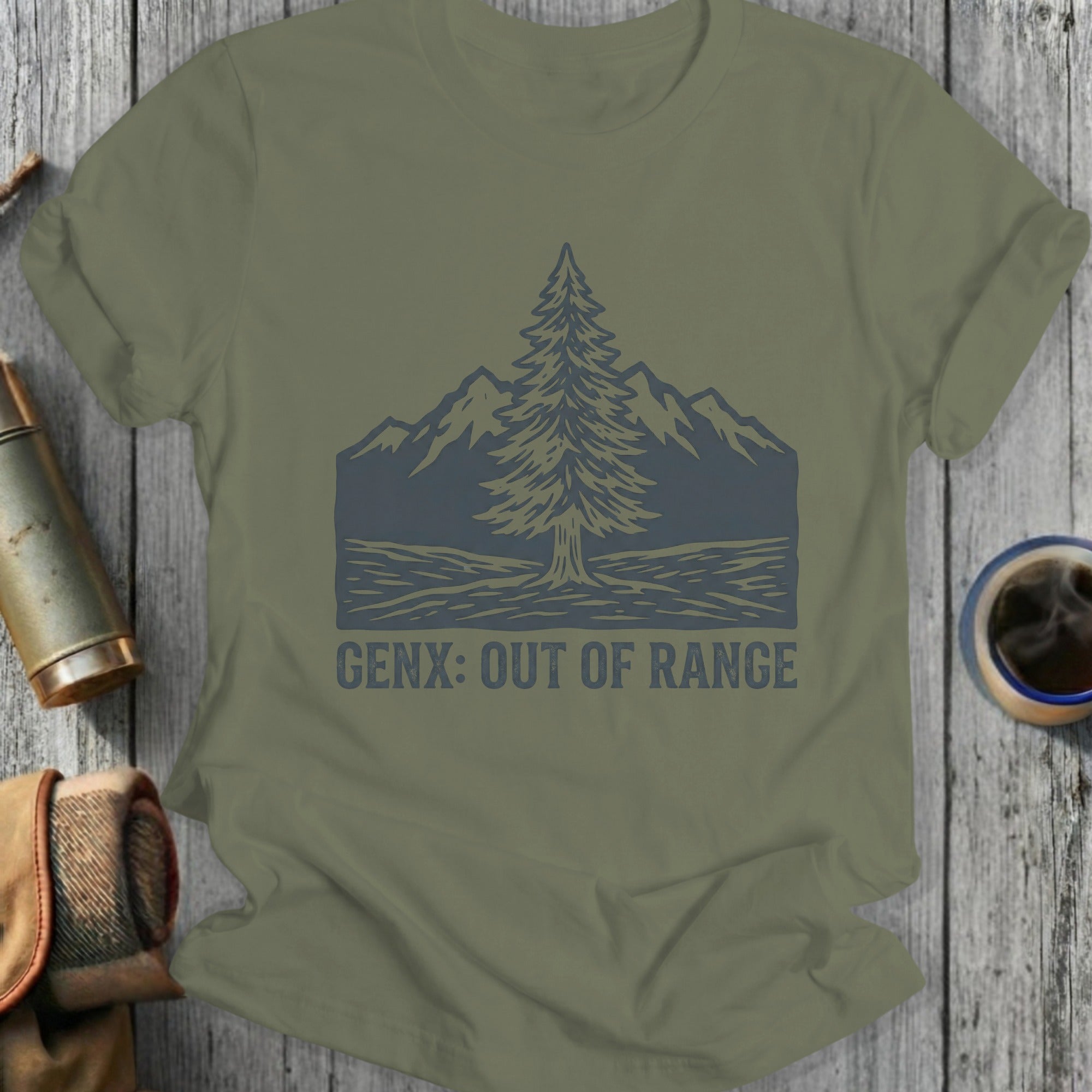 Olive green t-shirt with dark gray tree and mountain graphic and "GENX: OUT OF RANGE" text.