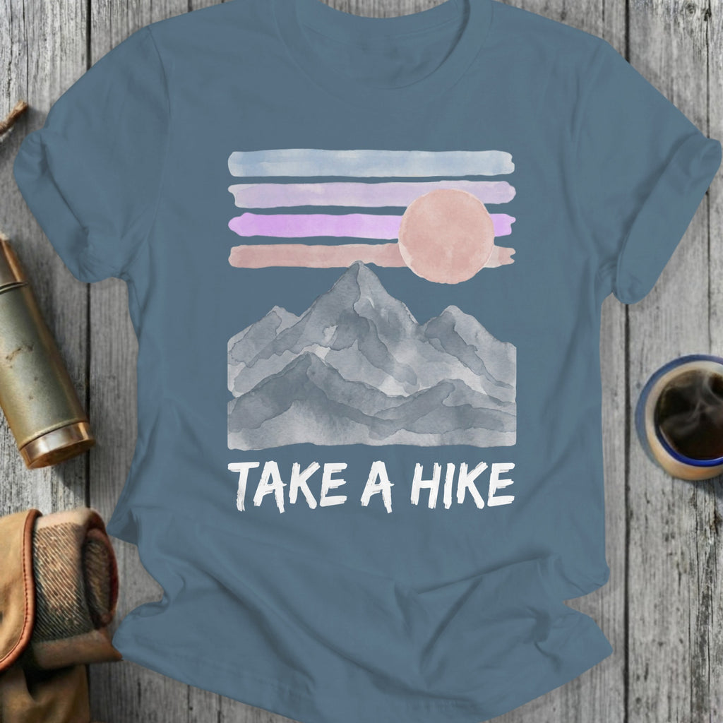 T-shirt with watercolor mountains, sun, and text "TAKE A HIKE".