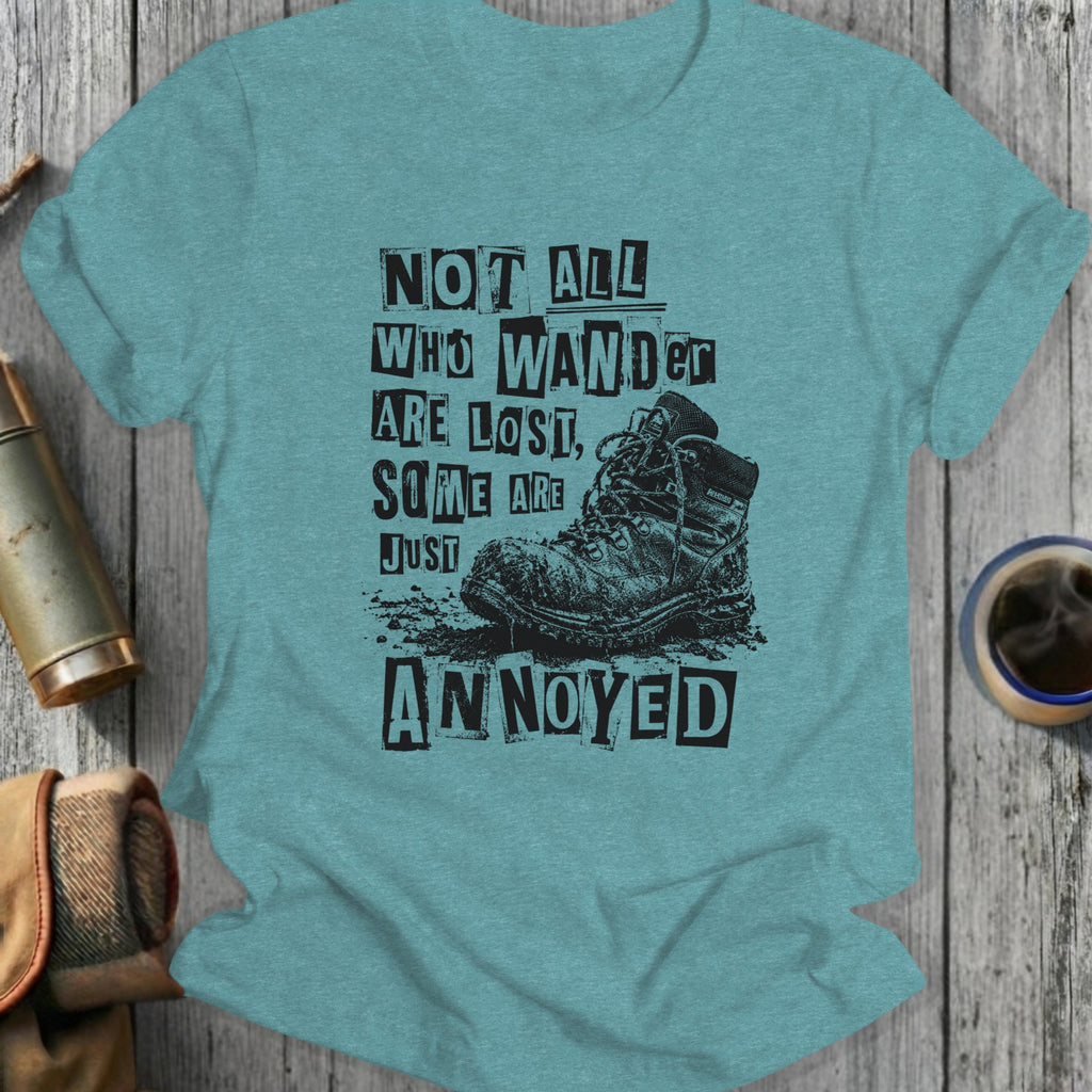 T-shirt with "Not all who wander are lost, some are just annoyed" and a muddy hiking boot.
