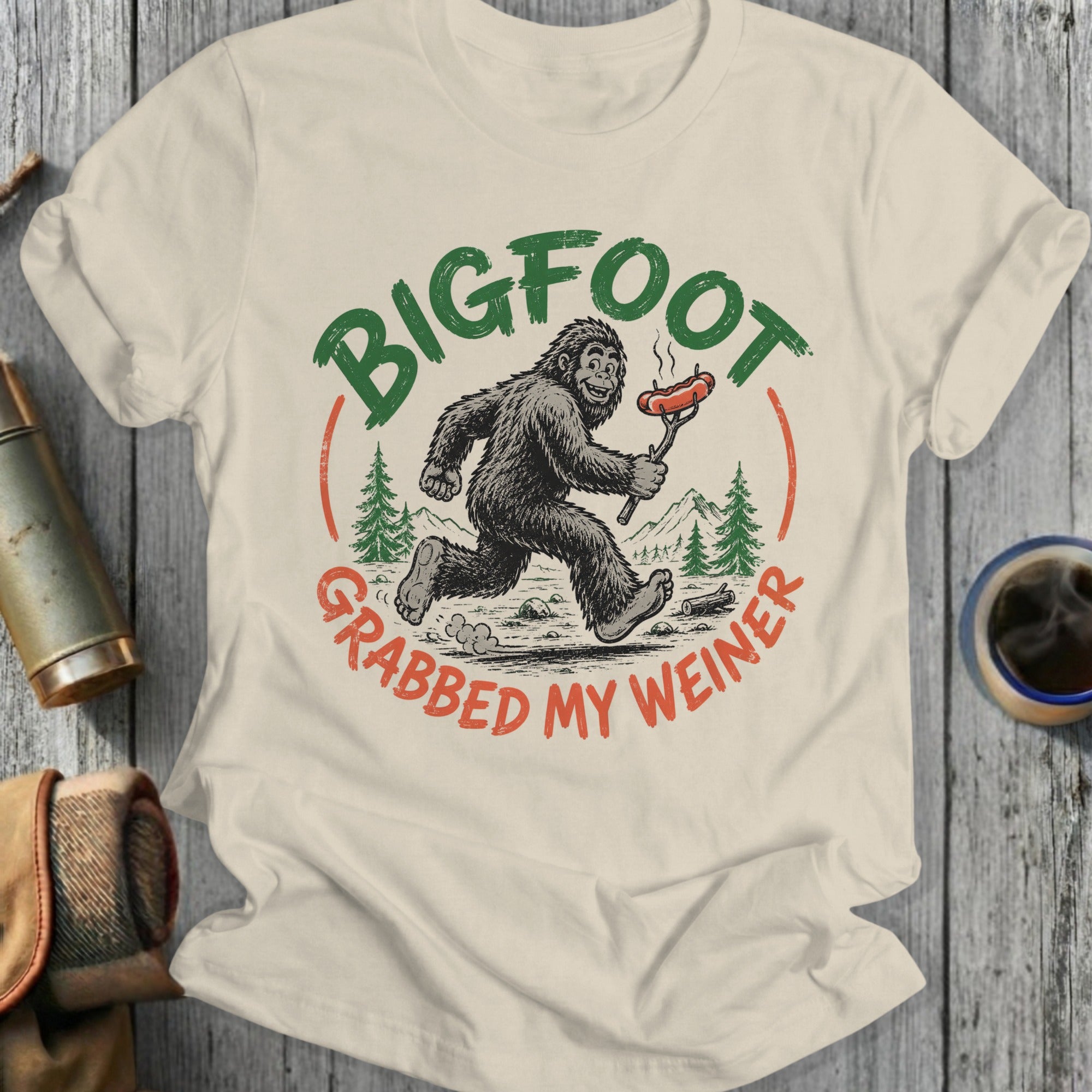 Bigfoot running with a hot dog, text reads "Bigfoot grabbed my weiner."