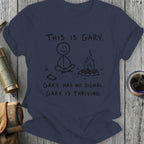 T-shirt with stick figure meditating by campfire, text says "This is Gary. Gary has no signal. Gary is thriving."