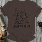 Brown t-shirt with alien and Bigfoot graphic and "LEAVE NO TRACE" text.