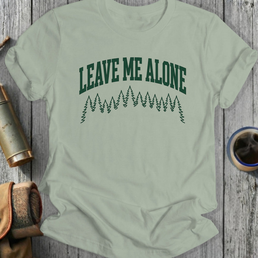 Green t-shirt with "Leave Me Alone" text and pine trees.