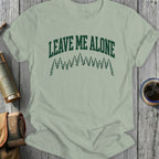 Green t-shirt with "Leave Me Alone" text and pine trees.