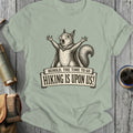 Squirrel in cape with arms outstretched on shirt, "Behold, The Time To Go Hiking Is Upon Us!"