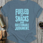 Fueled by snacks and questionable judgment text on a blue shirt.