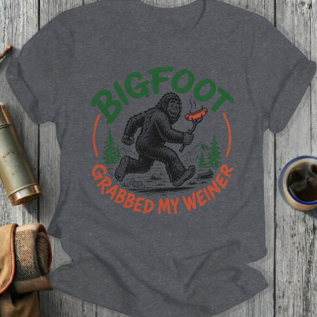 Bigfoot running with a hot dog on a stick, text says "Bigfoot grabbed my wiener".