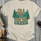 Cream t-shirt with "I'm a freak for the creek" text and stylized trees.