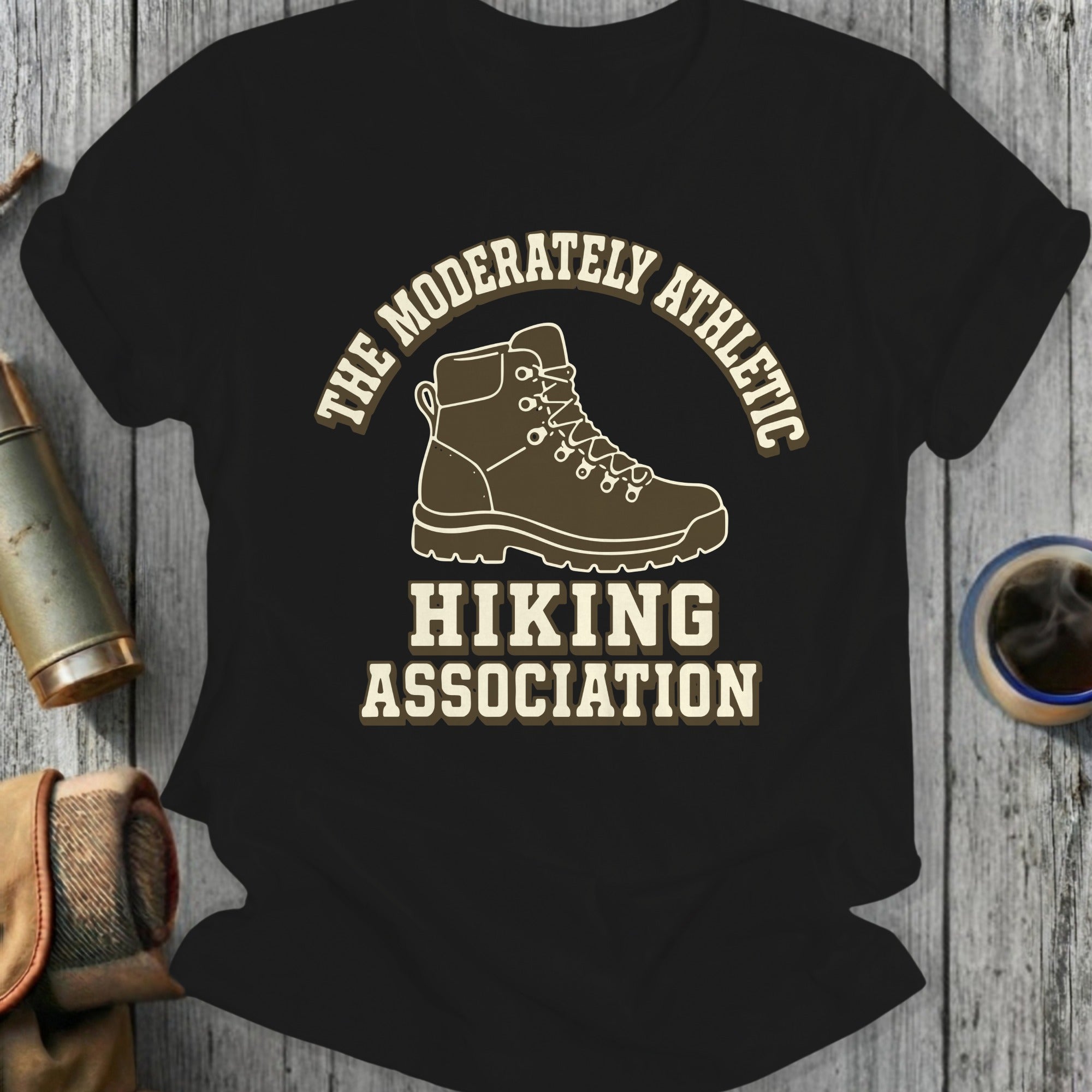Black t-shirt design with hiking boot, "The Moderately Athletic Hiking Association" text.