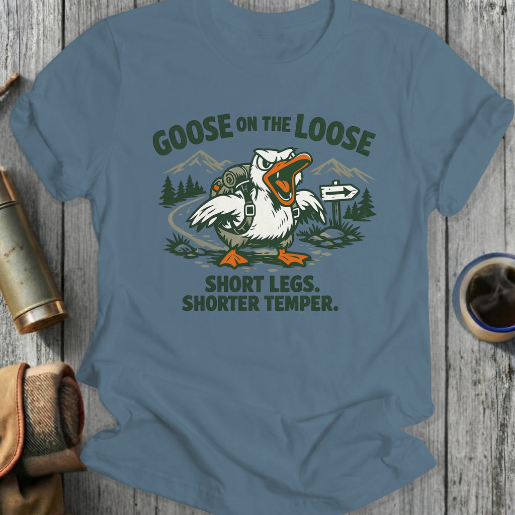 Goose with backpack on dirt path, text "Goose on the Loose Short Legs. Shorter Temper."